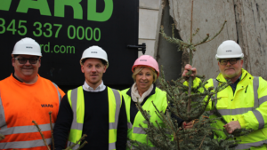 Image of Steve Crocker, Ben Stubbs, Mary Rose and Kevin Deller recycling Christmas trees